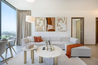a living room with a white couch and a table at Marco Polo - Experience luxury living with Burj Khalifa views in Dubai