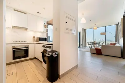 a kitchen and living room with a trash can at Marco Polo - Experience luxury living with Burj Khalifa views in Dubai