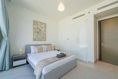 a bedroom with a large bed and a window at Marco Polo - Experience luxury living with Burj Khalifa views in Dubai