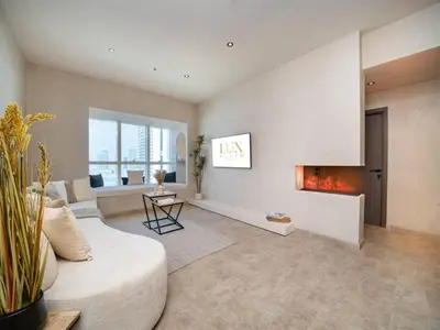 a living room with a couch and a fireplace at Upgraded Stylish Living with Private Steam Room in Dubai