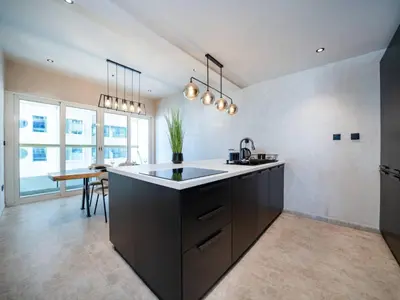 a kitchen with a sink and a counter top at Upgraded Stylish Living with Private Steam Room in Dubai