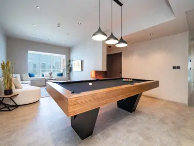a living room with a pool table in it at Upgraded Stylish Living with Private Steam Room in Dubai