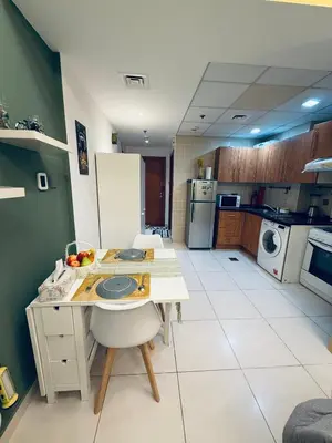 a kitchen with a table and a counter in it at Livincci - Luxury Studio in Dubai Marina - 15 in Dubai