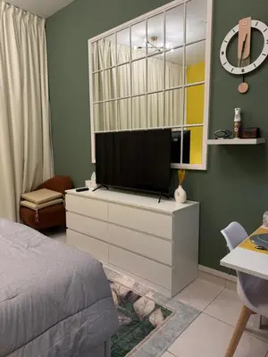a bedroom with a tv on a dresser at Livincci - Luxury Studio in Dubai Marina - 15 in Dubai