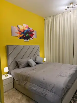 a bedroom with a bed and a yellow wall at Livincci - Luxury Studio in Dubai Marina - 15 in Dubai