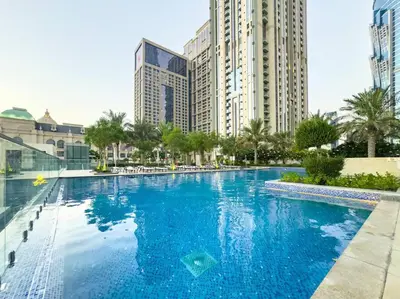 a large swimming pool in a city with tall buildings at Luxury Apt in Business Bay Water canal view in Dubai