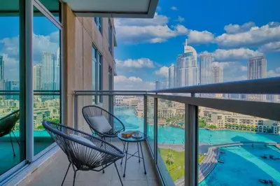 a balcony with two chairs and a view of the city at Cozy 1-Bedroom Apartment at Heart of Dubai in Dubai