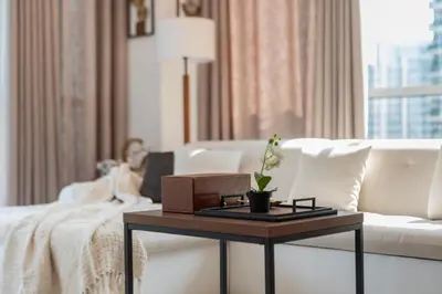 a living room with a white couch and a table at Cozy 1-Bedroom Apartment at Heart of Dubai in Dubai