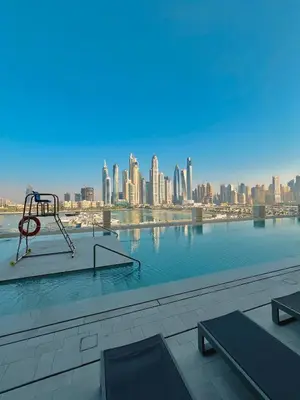 a pool with a view of a city skyline at Seaside Lux Retreat 2-BR Private Beach in Dubai