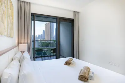 a hotel room with a bed with shoes on it at Beautiful Home with Full Burj View in Downtown in Dubai