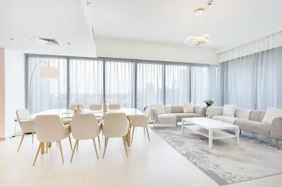 a living room with a table and chairs at Beautiful Home with Full Burj View in Downtown in Dubai