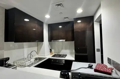 a kitchen with a sink and a stove top oven at Home away from home in Dubai