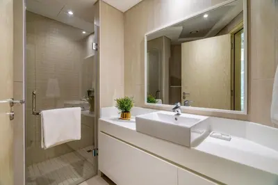 a bathroom with a sink and a mirror at GuestReady - Luxurious nest direct on JBR Beach in Dubai
