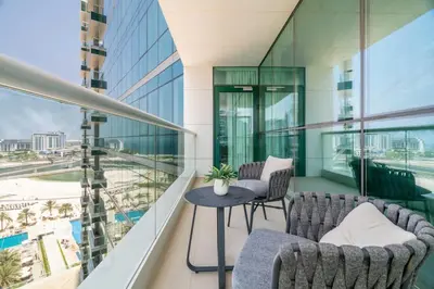 a balcony with two chairs and a table on a building at GuestReady - Luxurious nest direct on JBR Beach in Dubai