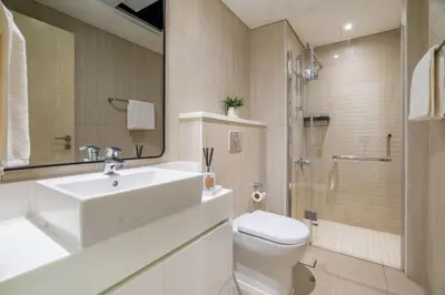 a bathroom with a sink and a toilet and a shower at GuestReady - Luxurious nest direct on JBR Beach in Dubai
