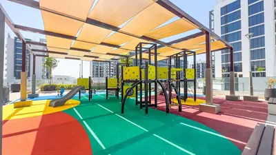 a play area with a playground with a slide at Escape24 Studio at Azizi Riviera near Business Bay in Dubai
