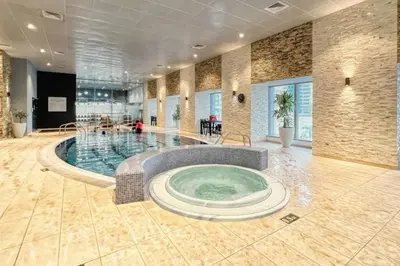 a large swimming pool in a large room at Luxury OneBedroom Apartment next to Barasti Beach in Dubai