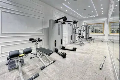 a gym with several exercise equipment in a room at Luxury OneBedroom Apartment next to Barasti Beach in Dubai