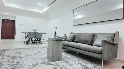 a living room with a couch and a table at Luxury OneBedroom Apartment next to Barasti Beach in Dubai