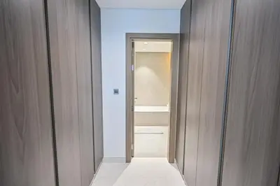 a hallway with a door leading to a bathroom at Stunning 1BR Retreat with Crystal Lagoon Views! in Dubai