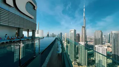 a pool on the top of a building with a view of a city at Paramount Midtown I Sky High Luxury 2BR Apartment with Burj Khalifa View & Highest Infinity Pool I Down Town Dubai in Dubai
