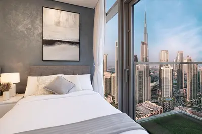 a bedroom with a bed and a large window at Paramount Midtown I Sky High Luxury 2BR Apartment with Burj Khalifa View & Highest Infinity Pool I Down Town Dubai in Dubai