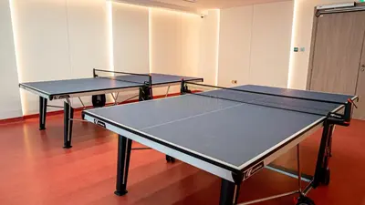 two ping pong tables in an empty room with at Stylish Brand New 1 Bedroom in Dubai