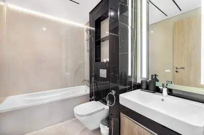 a bathroom with a sink and a toilet and a tub at Stylish Brand New 1 Bedroom in Dubai