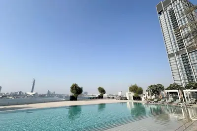 a large swimming pool next to a tall building at Address Opera 2BR Apartment 54th Floor in Dubai