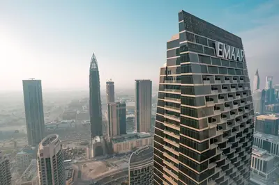 a building with a sign on the top of it in a city at Address Opera 2BR Apartment 54th Floor in Dubai