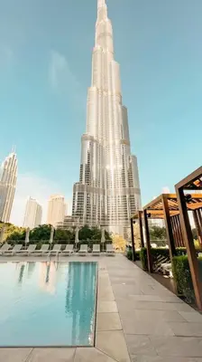 a large building with a swimming pool in front of it at Address Opera 2BR Apartment 54th Floor in Dubai