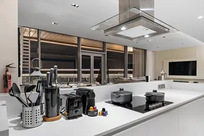 a kitchen with a white counter top with pots and pans at Bluewaters 5BR Panoramic Eye of Dubai Views Near JBR Beach in Dubai