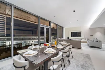 a dining room with a table and some chairs at Bluewaters 5BR Panoramic Eye of Dubai Views Near JBR Beach in Dubai