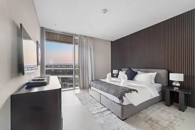 a bedroom with a large bed and a large window at Bluewaters 5BR Panoramic Eye of Dubai Views Near JBR Beach in Dubai