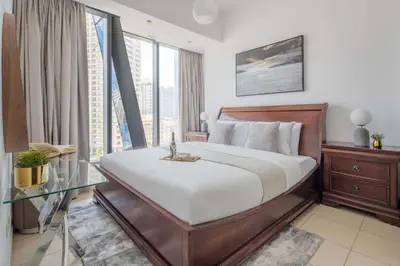 a bedroom with a bed and a glass table at Frank Porter - Silverene Tower B in Dubai