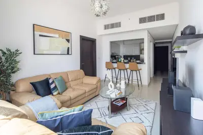 a living room with a couch and a table at Frank Porter - Silverene Tower B in Dubai