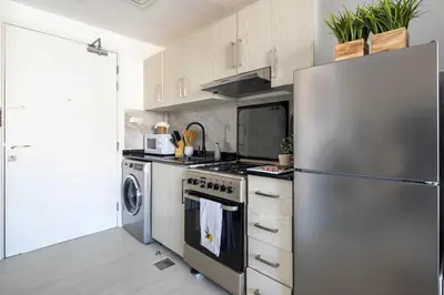 a kitchen with a stainless steel refrigerator and a stove at Frank Porter - Lakeside Tower C in Dubai