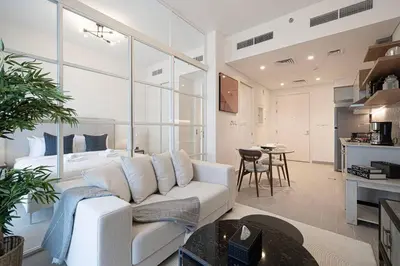 a living room with a white couch and a table at Cozy 1 - Bedroom Retreat in DHE in Dubai