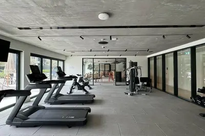 a gym with treadmills and ellipticals in a room at Cozy 1 - Bedroom Retreat in DHE in Dubai