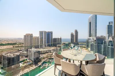 a view from the balcony of a building with a table and chairs at Deluxe Marina View 2BR - Stella Maris Retreat in Dubai