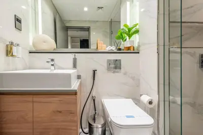 a bathroom with a sink and a toilet and a shower at Canal View Studio - 10 min to Dubai Mall - MAG 318 in Dubai
