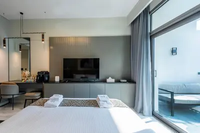 a bedroom with a bed and a large window at Canal View Studio - 10 min to Dubai Mall - MAG 318 in Dubai