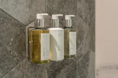 a group of four essential oils on a wall at Canal View Studio - 10 min to Dubai Mall - MAG 318 in Dubai