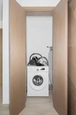 a washer and dryer in a room at Palace Residence Dubai Creek Harbour 1 Bd Apt in Dubai