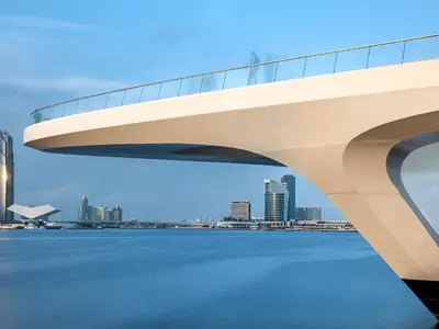 a bridge over the water with a city in the background at Palace Residence Dubai Creek Harbour 1 Bd Apt in Dubai