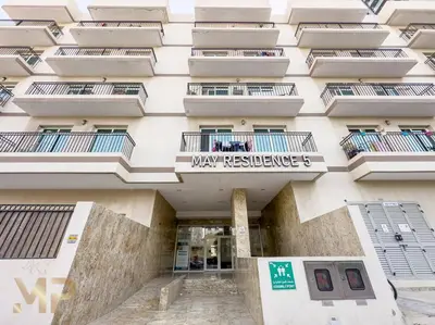 a building with a sign on the front of it at Marco Polo - Experience elegant living in JVC Dubai in Dubai