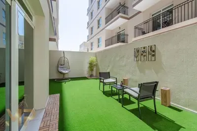 a room with a green floor in a building at Marco Polo - Experience elegant living in JVC Dubai in Dubai