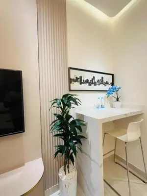 a white desk with a plant in a room at Damac Hills Carson studio on Golf Course in Dubai Marina