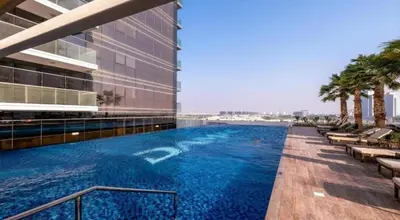 a swimming pool on the side of a building at Damac Hills Carson studio on Golf Course in Dubai Marina