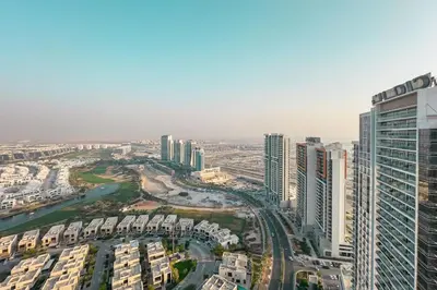 an aerial view of a city with tall buildings at Damac Hills Carson studio on Golf Course in Dubai Marina